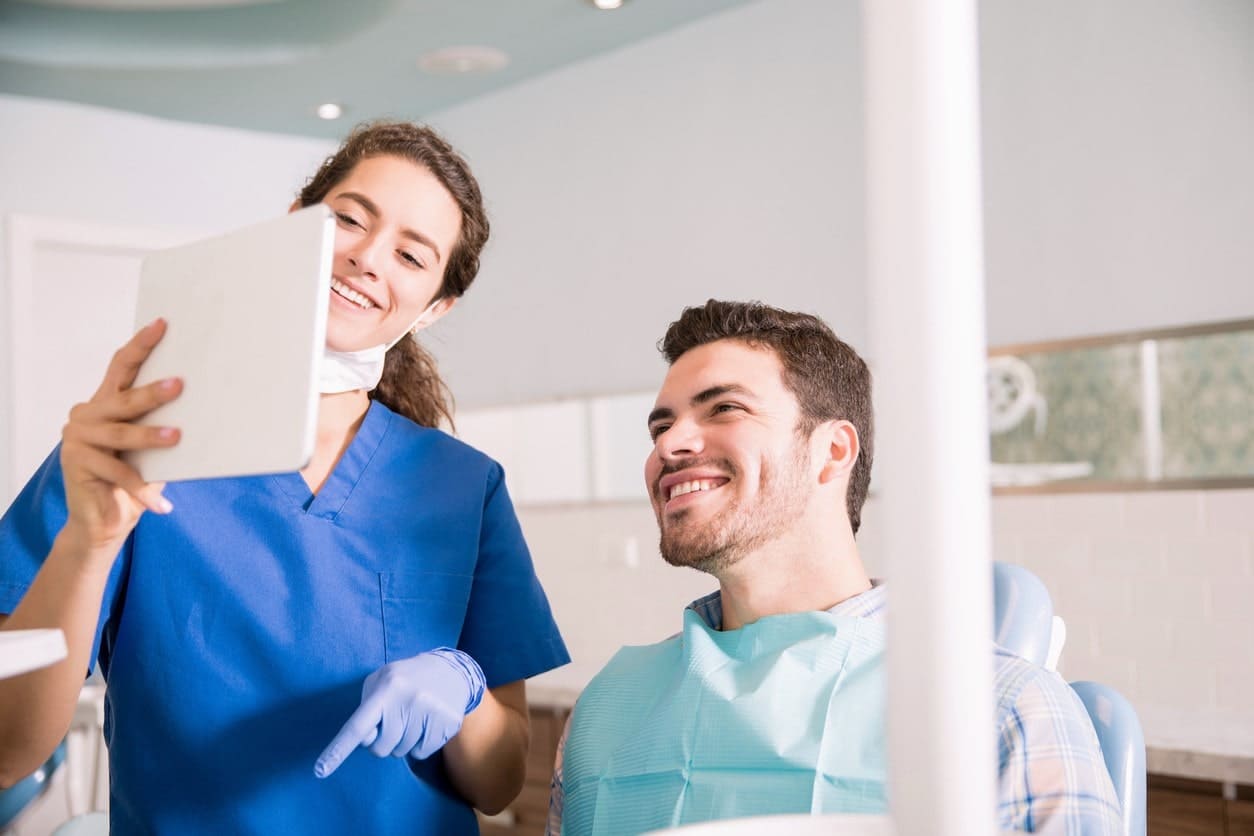 man in dentist chair smiling