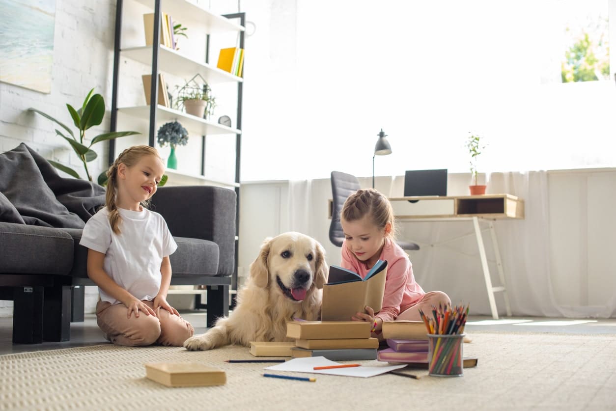 two girls playing with their dog