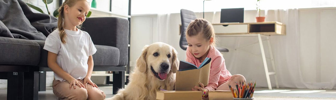 two girls playing with their dog